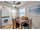 Cozy dining area with natural light, seating for four, laundry facilities and ceiling fan at 5101 Coquina Key Se Dr # A, St Petersburg, FL 33705