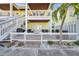 The two-story home includes an outdoor patio and upper-level balcony, all secured by a white picket fence at 5101 Coquina Key Se Dr # A, St Petersburg, FL 33705
