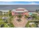 Beautiful pink condo building with a circular driveway and lush tropical landscaping at 5101 Coquina Key Se Dr # A, St Petersburg, FL 33705