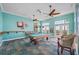 Bright game room with a pool table, ceiling fans, a TV and seating, perfect for recreation at 5101 Coquina Key Se Dr # A, St Petersburg, FL 33705