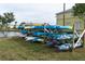 Kayak storage area features stacked kayaks on wooden racks near a waterfront and community buildings at 5101 Coquina Key Se Dr # A, St Petersburg, FL 33705
