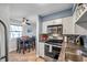 Modern kitchen with stainless steel appliances and adjacent dining area at 5101 Coquina Key Se Dr # A, St Petersburg, FL 33705