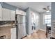 Modern kitchen with stainless steel refrigerator, white cabinets, and convenient in-unit laundry at 5101 Coquina Key Se Dr # A, St Petersburg, FL 33705