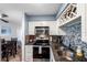 Updated kitchen features white cabinets, stainless steel appliances, mosaic tile backsplash, and wine rack at 5101 Coquina Key Se Dr # A, St Petersburg, FL 33705