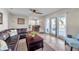 Comfortable living room with tile flooring, ceiling fan and sliding glass door to the patio at 5101 Coquina Key Se Dr # A, St Petersburg, FL 33705