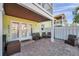 Rear view of a waterfront home featuring a brick patio with furniture, perfect for relaxation and outdoor living at 5101 Coquina Key Se Dr # A, St Petersburg, FL 33705