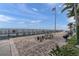 Community patio featuring picnic tables, grills, and a dock with ocean views, perfect for outdoor gatherings at 5101 Coquina Key Se Dr # A, St Petersburg, FL 33705