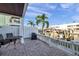Brick patio with table and chairs overlooking a scenic waterfront with boat docks and luxury residences at 5101 Coquina Key Se Dr # A, St Petersburg, FL 33705