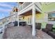 The patio features a brick floor and ample seating, along with a staircase to an upper-level balcony at 5101 Coquina Key Se Dr # A, St Petersburg, FL 33705
