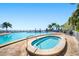 Outdoor pool with hot tub with a clear sky and palm trees in the background at 5101 Coquina Key Se Dr # A, St Petersburg, FL 33705
