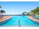 Inviting swimming pool and hot tub with views of the water and poolside seating areas at 5101 Coquina Key Se Dr # A, St Petersburg, FL 33705