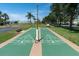 Outdoor shuffleboard courts with clear markings, surrounded by trees and benches at 5101 Coquina Key Se Dr # A, St Petersburg, FL 33705