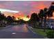 Street view features a vibrant sunset sky over a neighborhood road lined with lush palm trees at 5101 Coquina Key Se Dr # A, St Petersburg, FL 33705