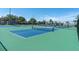 A set of community tennis courts showcases blue and green surfaces with black fencing and nets at 5101 Coquina Key Se Dr # A, St Petersburg, FL 33705