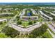 Aerial view showcasing the community's layout, landscaping, pond, and building exteriors at 6070 80Th N St # 109, St Petersburg, FL 33709