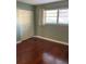 Bedroom featuring a double closet, hardwood floor, and natural light from the window at 6070 80Th N St # 109, St Petersburg, FL 33709