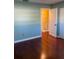 View of room with hardwood floors, closet and doorway to a room with yellow wall at 6070 80Th N St # 109, St Petersburg, FL 33709