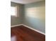 Cozy bedroom space featuring a window and hardwood flooring at 6070 80Th N St # 109, St Petersburg, FL 33709