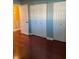 Bedroom with wood flooring and white closet doors at 6070 80Th N St # 109, St Petersburg, FL 33709