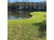 Building exterior near a pond with manicured green lawn at 6070 80Th N St # 109, St Petersburg, FL 33709