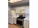 Kitchen with white appliances and tile flooring at 6070 80Th N St # 109, St Petersburg, FL 33709