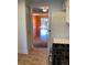 View from kitchen shows door frame and living room with wood floors at 6070 80Th N St # 109, St Petersburg, FL 33709