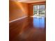 Well-lit room boasting gleaming hardwood floors and a sliding door to a balcony at 6070 80Th N St # 109, St Petersburg, FL 33709