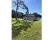 Scenic view of a tranquil pond surrounded by lush landscaping and residential buildings, offering a serene living environment at 6070 80Th N St # 109, St Petersburg, FL 33709