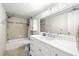 Bathroom featuring a white vanity, tiled shower, and tub combo at 6100 Gulfport S Blvd # 414, Gulfport, FL 33707