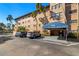 Beautiful condo building with covered entrance and parking spaces for residents and visitors at 6100 Gulfport S Blvd # 414, Gulfport, FL 33707