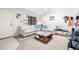 Bright living room features neutral paint, tile, a ceiling fan, lots of seating and lots of natural light at 6100 Gulfport S Blvd # 414, Gulfport, FL 33707