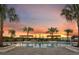Community pool with palm trees, pergola, and sunset sky at 6217 Golden Beach Dr, Apollo Beach, FL 33572