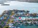 An aerial shot shows waterfront houses with docks and ocean access in a developed area at 720 Capri Blvd, Treasure Island, FL 33706