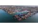 Aerial view of waterfront homes with boat docks in a coastal community at 720 Capri Blvd, Treasure Island, FL 33706
