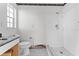 Bright bathroom space with a standing shower, vanity, and tiled floor ready for renovation at 720 Capri Blvd, Treasure Island, FL 33706