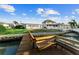 Waterfront home featuring a private dock with seating, perfect for relaxing by the canal at 720 Capri Blvd, Treasure Island, FL 33706