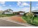 Exterior view of brick home with brick driveway with a two car garage at 720 Capri Blvd, Treasure Island, FL 33706