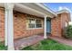Charming brick home exterior featuring brick porch with white columns and blue door at 720 Capri Blvd, Treasure Island, FL 33706