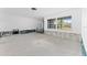 Spacious living room under construction featuring a brick wall and exposed framing, awaiting renovation at 720 Capri Blvd, Treasure Island, FL 33706