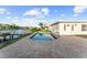 Inviting pool with brick surround, perfect for enjoying sunny days by the water at 720 Capri Blvd, Treasure Island, FL 33706