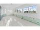 Bright sun room space with white tiled floors ready for renovation at 720 Capri Blvd, Treasure Island, FL 33706