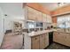 Kitchen area with countertop bar area, and open dining area beyond at 7910 Jackson Springs Rd, Tampa, FL 33615