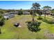 Aerial view of the large grassy yard with mature trees and utility trailer at 8437 Indies Dr, Hudson, FL 34667
