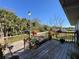 Spacious back deck, great for entertaining with potted plants and wooden railings at 8437 Indies Dr, Hudson, FL 34667