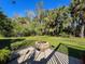 The backyard features a paved firepit area surrounded by vibrant greenery, offering a cozy outdoor space at 8437 Indies Dr, Hudson, FL 34667
