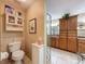 Well-lit bathroom featuring toilet, vanity, large shower and lots of storage at 8437 Indies Dr, Hudson, FL 34667