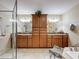 Bathroom showcasing a large vanity with double sinks, wooden cabinets, and separate shower at 8437 Indies Dr, Hudson, FL 34667
