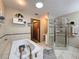 This bathroom is equipped with a large soaking tub and a glass-enclosed shower at 8437 Indies Dr, Hudson, FL 34667