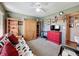 Spare bedroom with ceiling fan, futon, desk and an abundance of storage at 8437 Indies Dr, Hudson, FL 34667