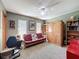This bedroom features a cozy futon, a ceiling fan, and ample storage within the built-in shelving at 8437 Indies Dr, Hudson, FL 34667